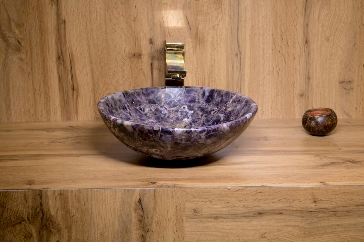 Round stone basin with curvatures on the outer part for your beautiful home