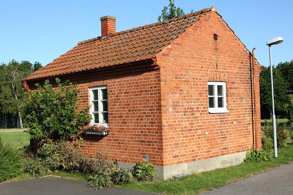 Low cost single floor house design with exposed bricks